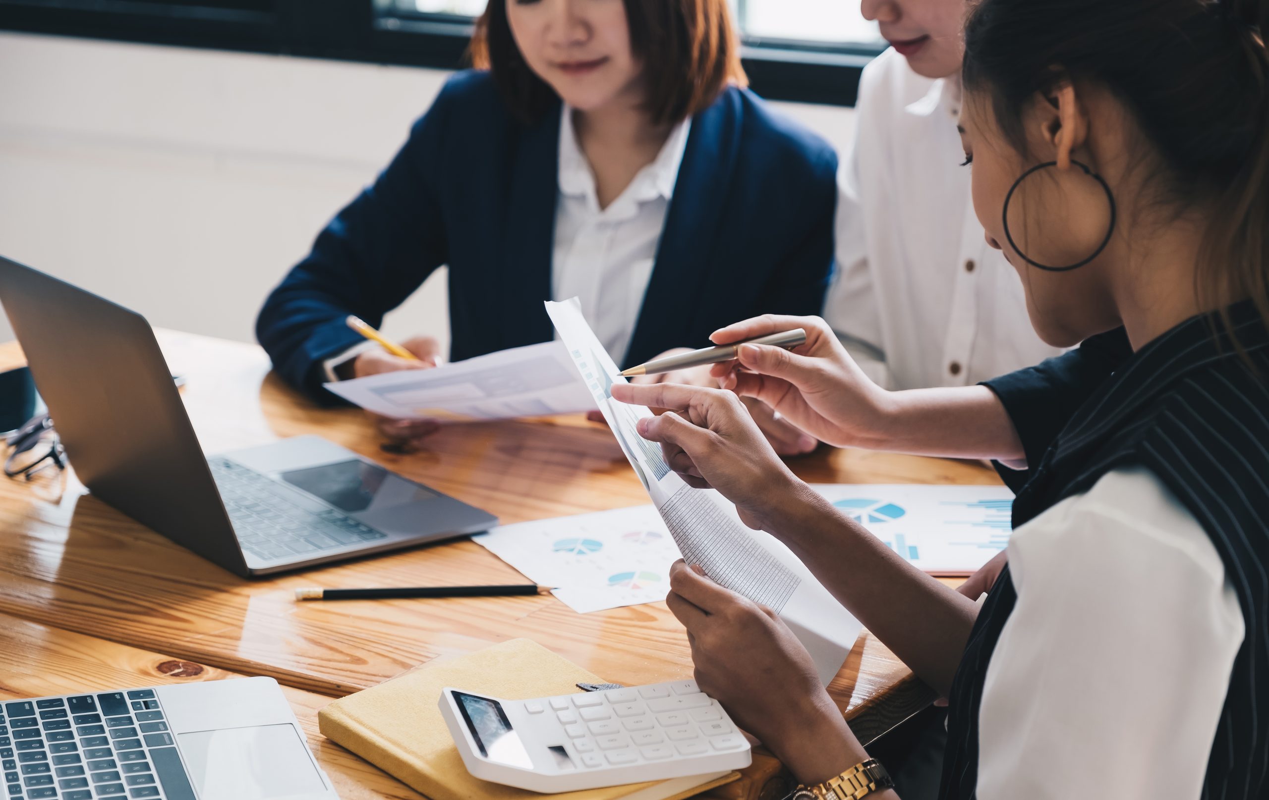 Asian business adviser meeting to analyze and discuss the situation on the financial report in the meeting room.Investment Consultant,Financial advisor and accounting concept