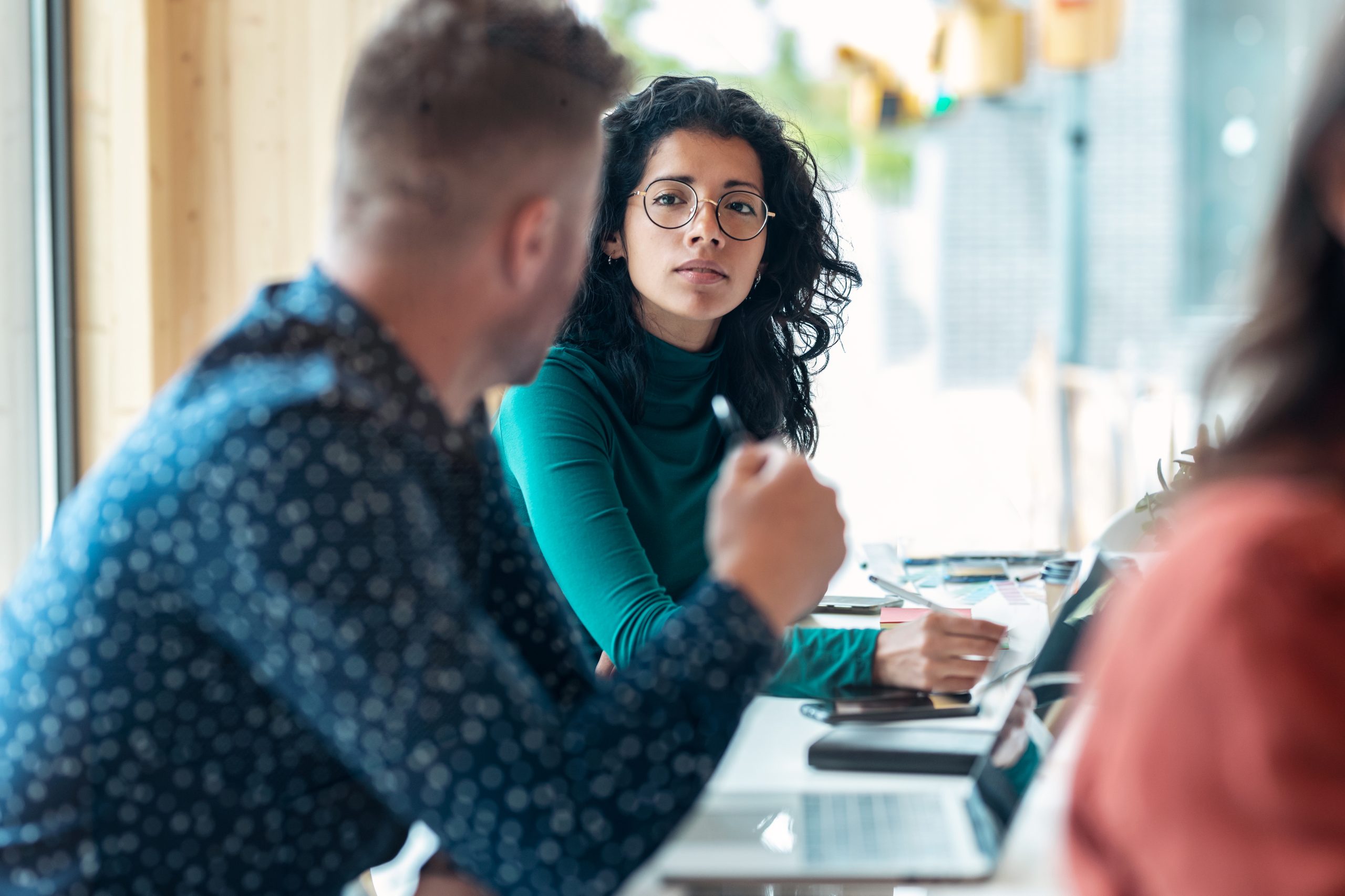 Group of professionals engaged in a meeting, discussing legal or business strategies.